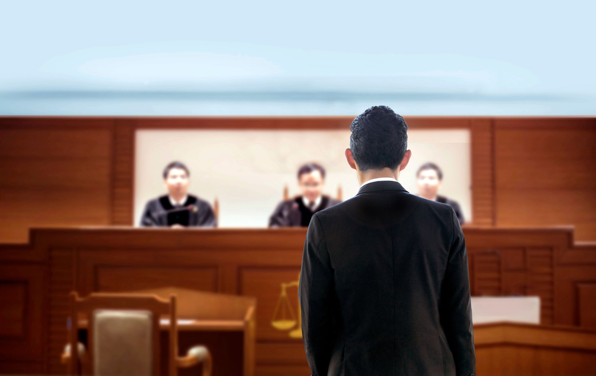 Attorney standing before a three-judge appellate panel