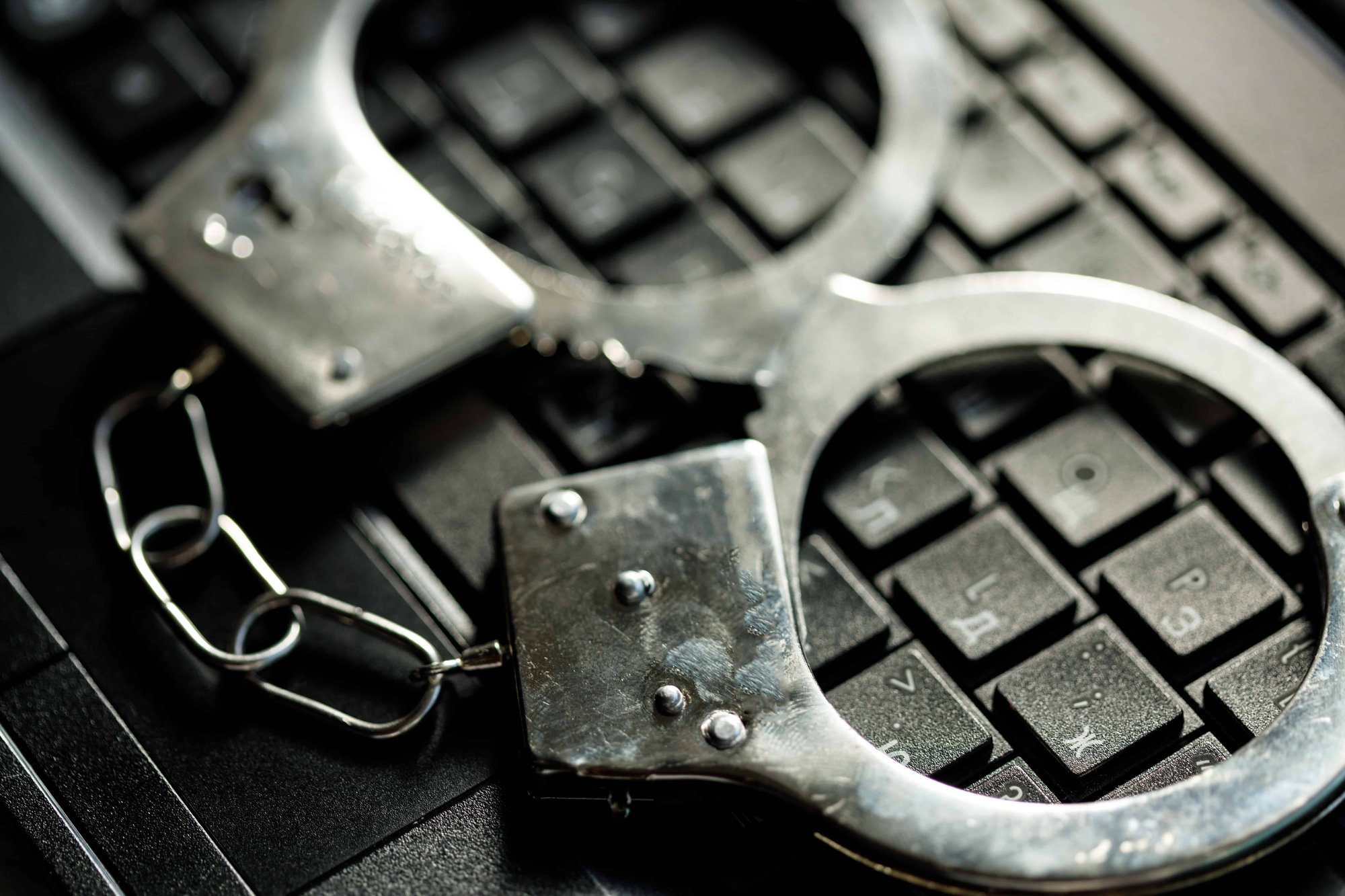 Handcuffs on laptop keyboard.