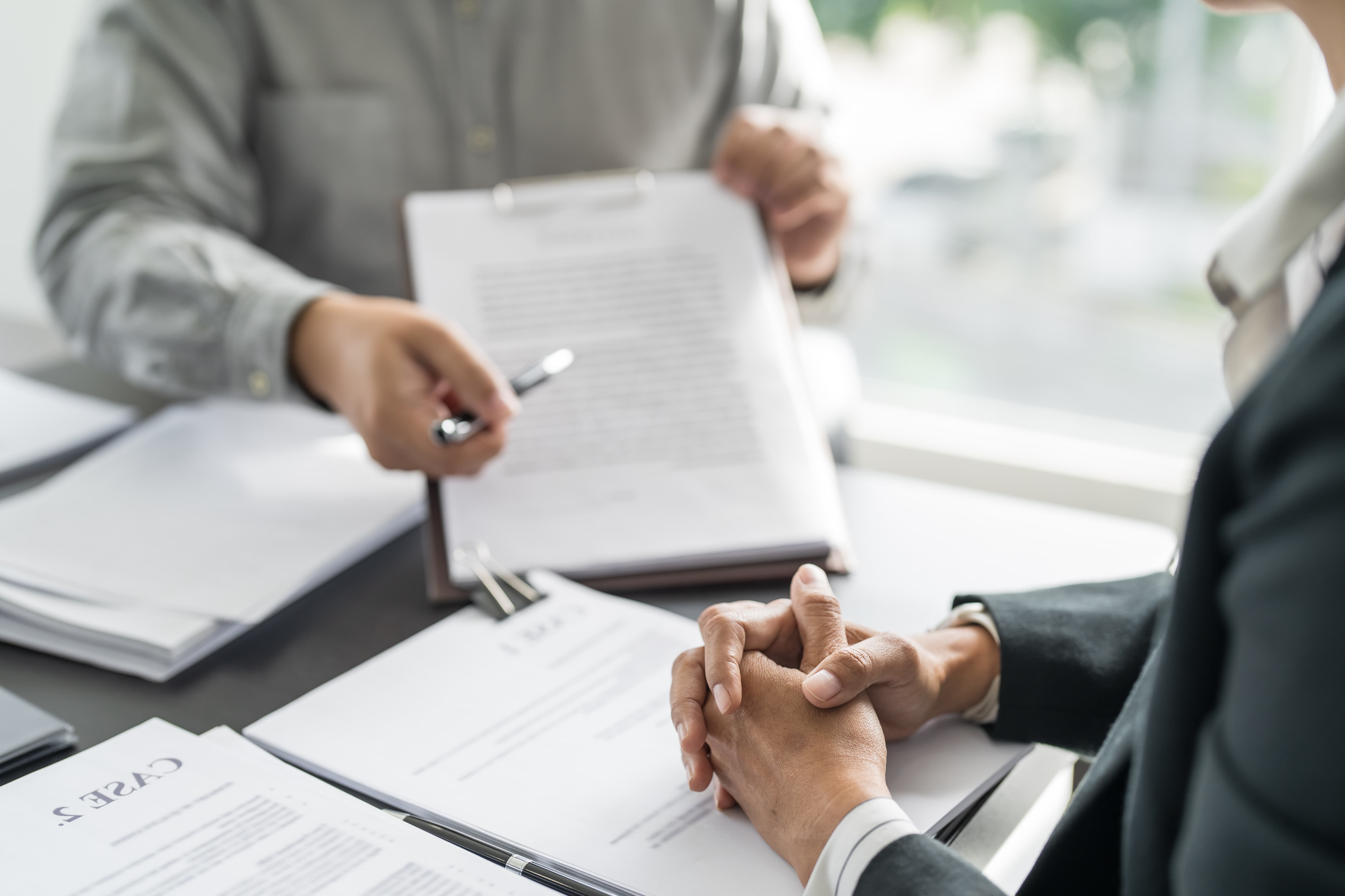 Legal advisor presents a contract to the client