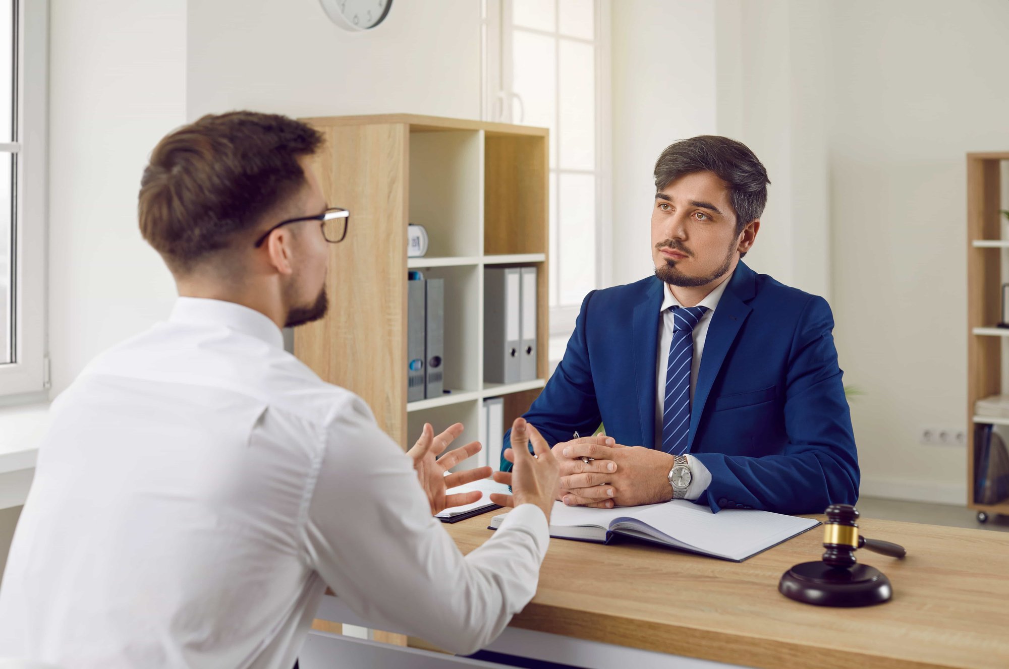 Young man consulting a lawyer in office