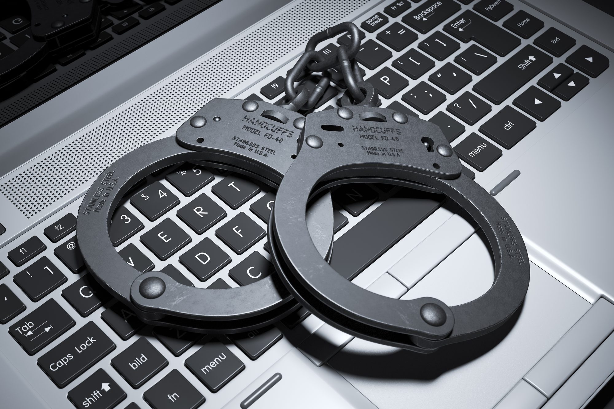 Handcuffs on a laptop keyboard