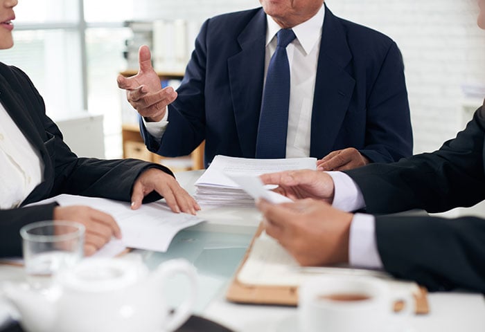 Three founders wearing formal outfit in a business meeting.