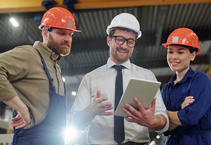 A business owner discussing a plan with his employees.