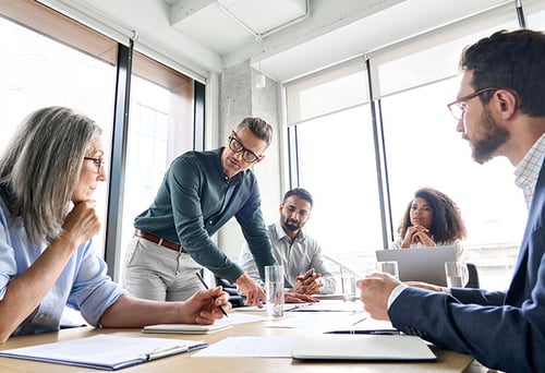 A department head in a meeting room with his members.
