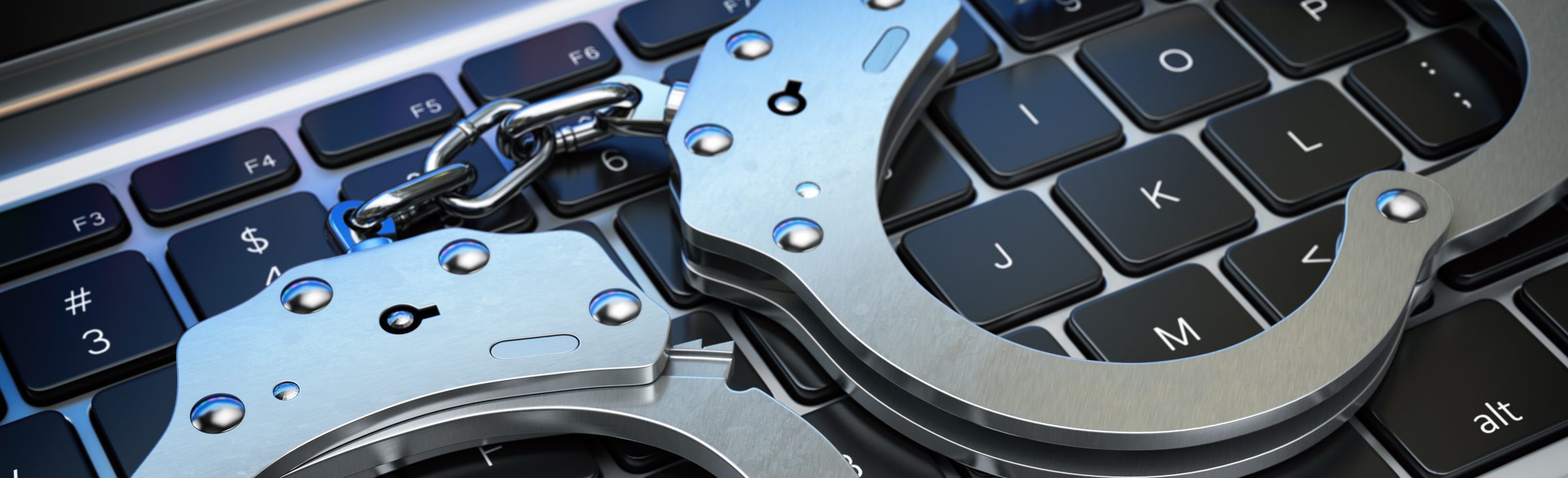 Handcuffs on a laptop keyboard