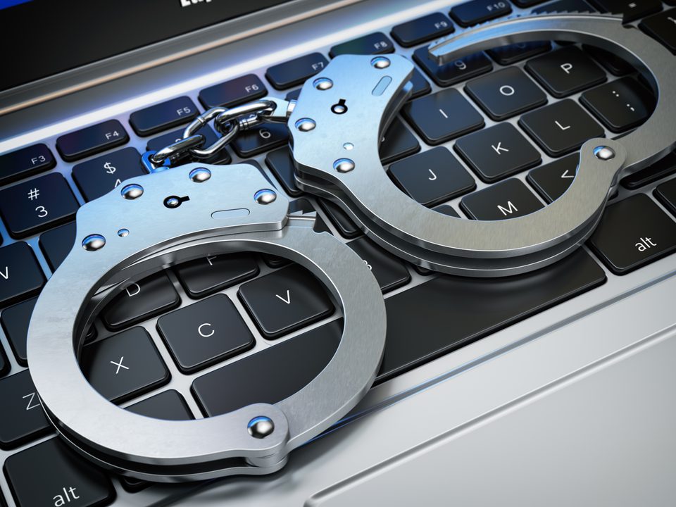 Handcuffs on a laptop keyboard