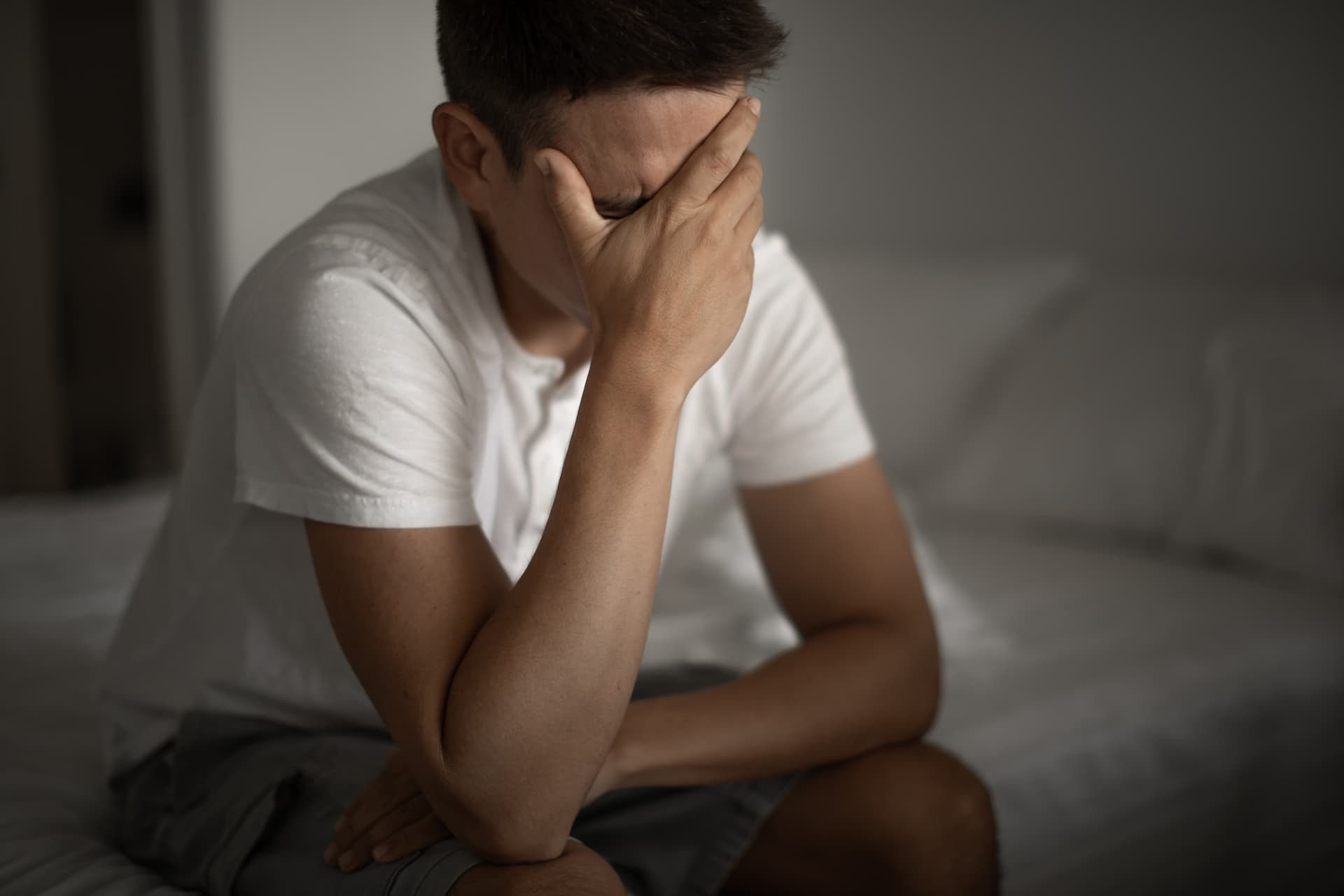 worried-man-holding-his-head-down