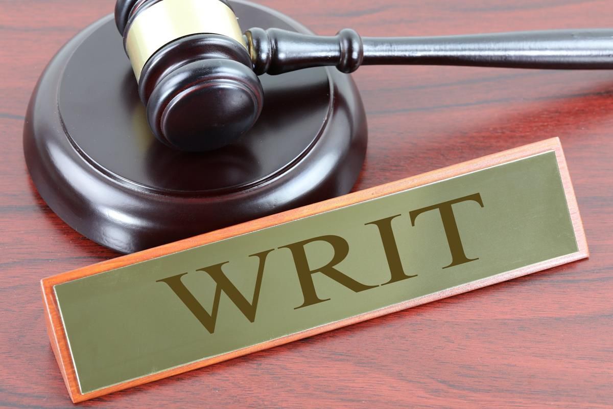 Gavel beside a sign that reads Writ